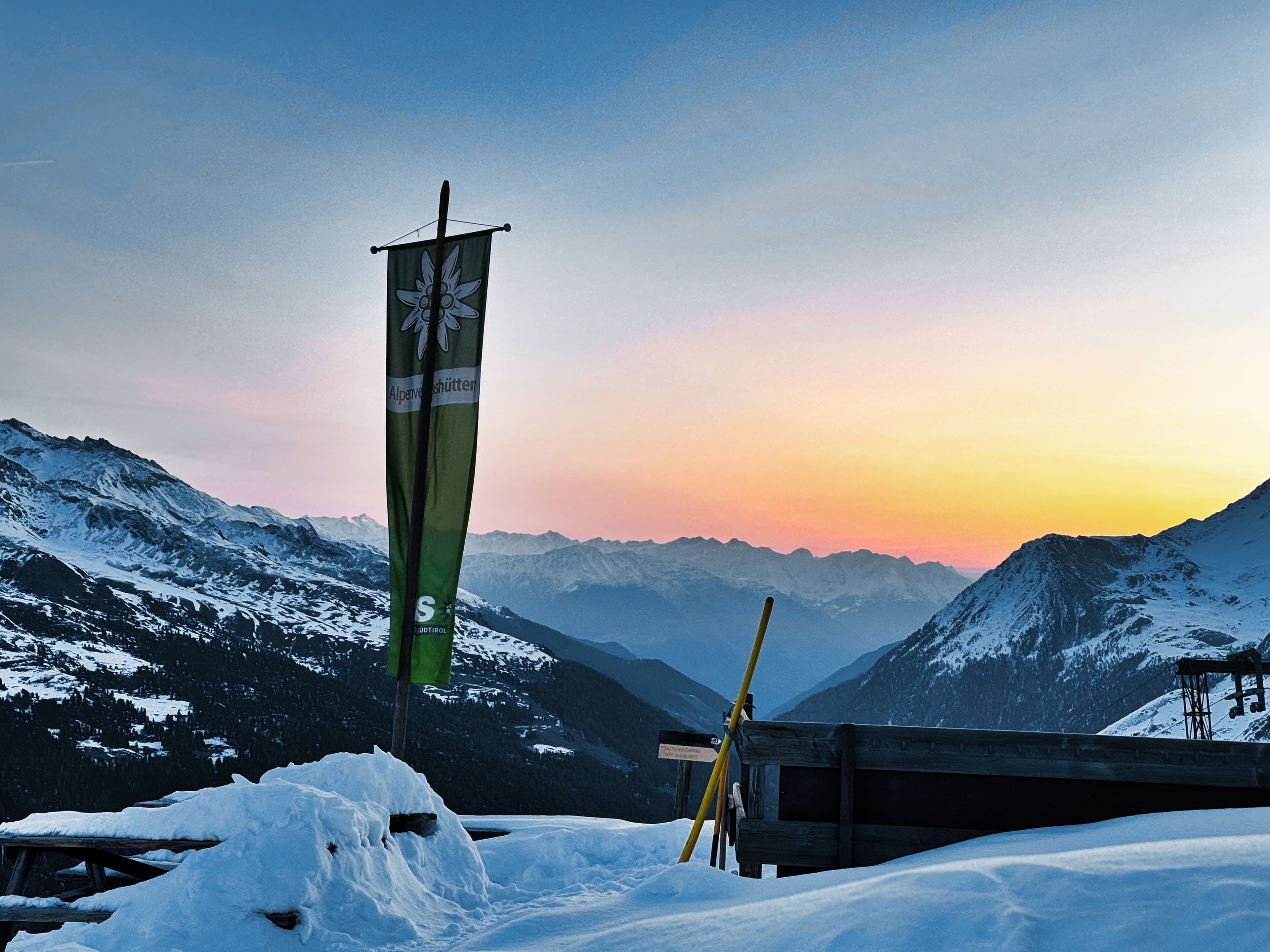 Sunset over the valley from a mountain hut terrace
